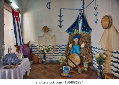 Trinidad, Cuba - May 23, 2015: Santeria Church With An Altar, The Cuban Flag, A Table, Some Drawings On The Wall, In Day Time, In Trinidad, Cuba.