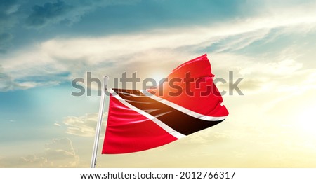 Trinidad and Tobago national flag waving in beautiful clouds.