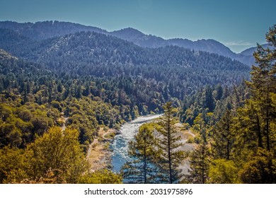 Trinity River in Northern California before the 2021 wildfires with rapids and tree covered hills in the background