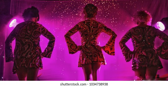 trio of female performers on stage about to begin their act - Shutterstock ID 1034738938