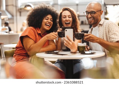 Trio of friends capture the moment with a fun selfie while enjoying each other's company over steaming cups of coffee in a comfortable cafe setting, surrounded by the aroma of freshly brewed coffee. - Powered by Shutterstock