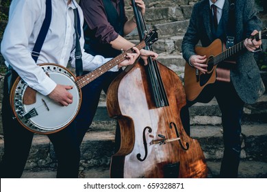 Trio of musicians with a guitar, banjo and contrabass - Shutterstock ID 659328871