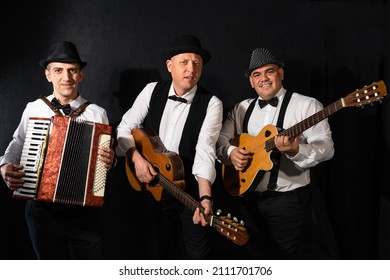 Trio of musicians on a black background	