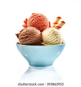 Trio of tasty chocolate vanilla and strawberry flavored frozen dessert in a blue bowl with two wafer straws - Shutterstock ID 393863953