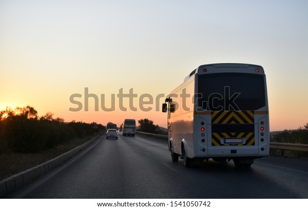 trip on taxi
bus by countryside road in
sunset