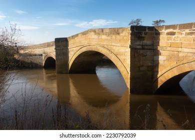 Triple arched Newsham Bridge near Malton with the River Rye running very high under it. - Shutterstock ID 2230792039