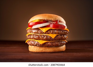Triple burger with cheddar onion and tomato