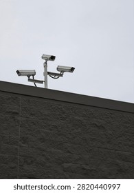 A Triple Camera Array on Top of Concrete Building Roof