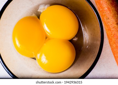 Triple Egg Yolk In A Small Soup Bowl