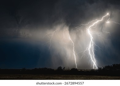 Triple lightning strike at close range through a downburst of rain
