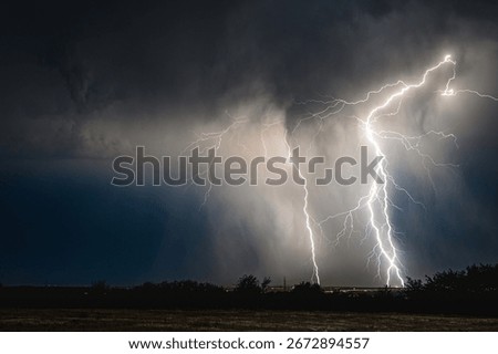 Triple lightning strike at close range through a downburst of rain
