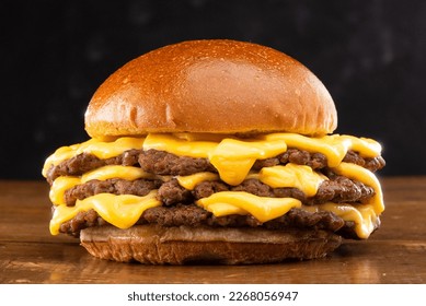 triple smash burger ith cheddar cheese in wood table