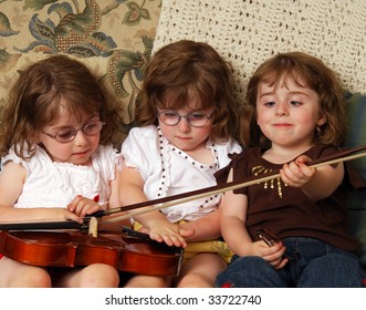 Triplets Playing With A Violin