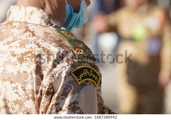 Tripoli, Libya - December 24, 2020: A\
soldier with emblem of the Libyan army in Martyrs Square at the\
celebration the 69th Anniversary of Libyan\
Independence.