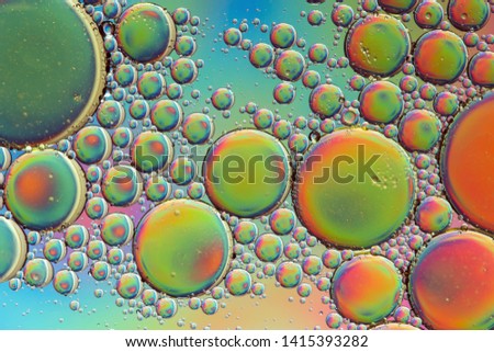 Trippy psychedelic abstract formed by oil droplets floating on water