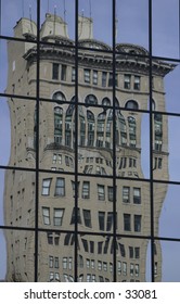 Trippy reflection of building in windows.