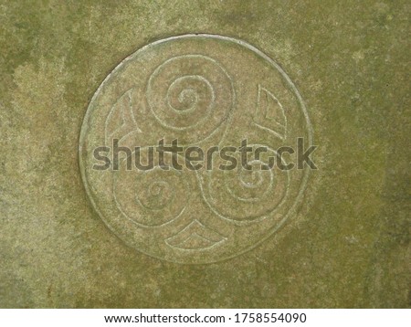 Triskelion symbol carved in stone