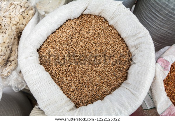 Triticale seeds in a\
sack bag at the\
market