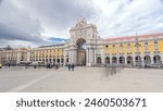 Triumphal arch at Rua Augusta at Commerce square timelapse hyperlapse in Lisbon, Portugal. Cloudy sky. After the great 1775 Lisbon earthquake earthquake the square was completely remodeled.