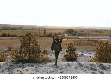 Triumphant hiker celebrates at the peak of a mountain with breathtaking panoramic landscape views - Powered by Shutterstock