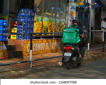 TRIVANDRUM, KERALA, INDIA,  DECEMBER 25, 2018: Uber Eats, Food Delivery People. Delivery Boy With The Unique Green Back Bag On His Bike, Probably Checking Delivery Address.