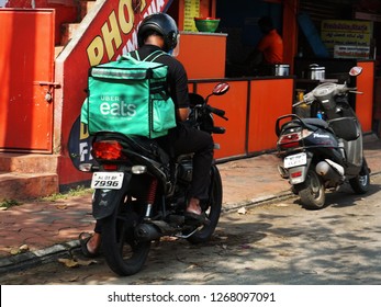 TRIVANDRUM, KERALA, INDIA,  DECEMBER                          25, 2018: Uber Eats, Food Delivery People. Delivery Boy With The Unique Green Back Bag On His Bike, Probably Checking Delivery Address.