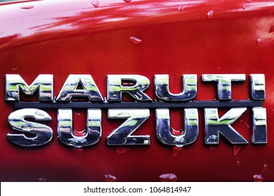 TRIVANDRUM, KERALA, INDIA, MARCH 29, 2018:  Shiny Emblem Of Maruti Suzuki Car On A Red Car After The Rains. Atmanirbhar Bharat. Make In India.