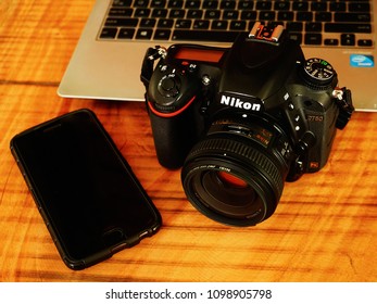 TRIVANDRUM, KERALA, INDIA, MAY 26, 2018: Photographer's Rustic Post-processing Work Bench. Overhead View Of A Nikon DSLR D750 Camera, A Laptop And A Mobile Phone On A Wooden Table. Stock Photography.