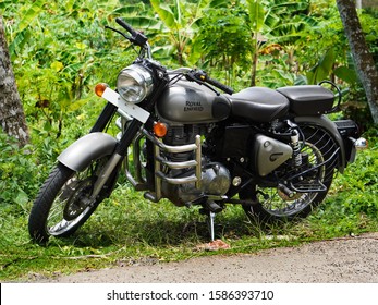 Trivandrum, Kerala, India, September 14, 2019: Macho Royal Enfield Bullet 350 cc motor cycle, parked in a farm on a bright day.                              