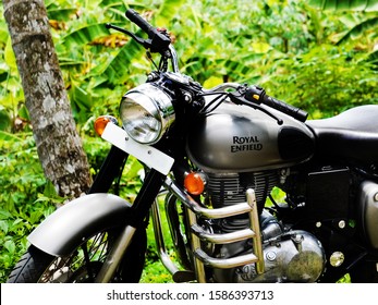 Trivandrum, Kerala, India, September 14, 2019: Royal Enfield Bullet 350 cc motor cycle, parked in a farm on a bright day.                              