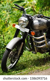 Trivandrum, Kerala, India, September 14, 2019: Royal Enfield Bullet 350 cc motor cycle, parked in a farm on a bright day.                              