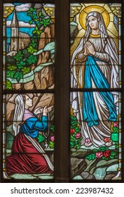 TRNAVA, SLOVAKIA - OCTOBER 14, 2014: The Virgin Mary of Loures and st. Bernadette Soubirous windowpane in St. Nicholas church and Virgin Mary chapel.