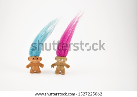 Troll figure stock images. Elf on a white background. Hairy troll. Troll girl and boy figure. Troll toy images. Two trolls isolated on a white background. Couple of trolls