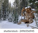 Troll sculpture in snowy forest