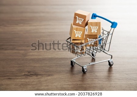Trolley shopping cart which print screen on wooden cubes block. Shopping Concept