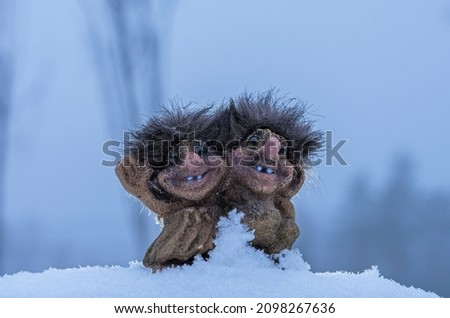 Trolls in the winter snowy landscape of Scandinavia