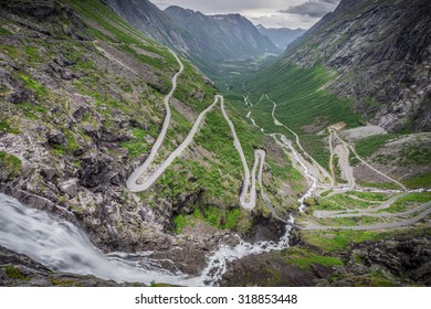 Trollstigen, Norway. The World Famous Curvy Road Of Trollstigen With A Cloudy Sky On The Background.