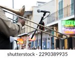 A trombone player performing on Bourbon Street in the historic French Quarter neighborhood in New Orleans, LA.