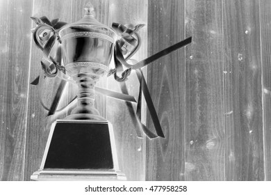 Trophy award on wood background with infrared image