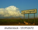 Tropic of Capricorn sign with thunderclouds in the rain season in Namibia.
