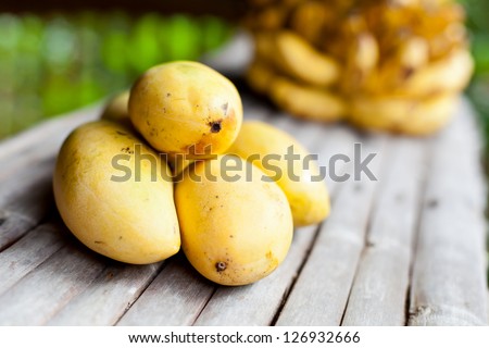 Tropic fruits closeup on wooden table