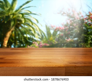 Tropical Background With Palm Tree And Wooden Table For Product