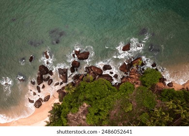 Tropical beach aerial drone shot, ocean waves crashing on beach rocks - Powered by Shutterstock