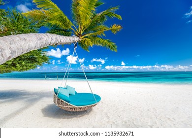 Tropical beach background as summer landscape with beach swing or hammock and white sand and calm sea for beach banner. Perfect beach scene vacation and summer holiday concept. Boost up color process