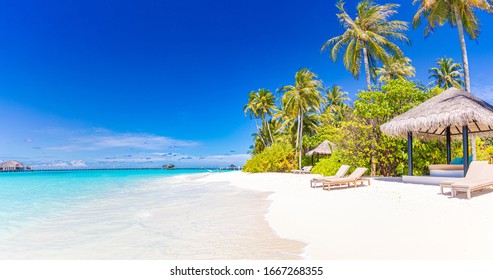 Tropical beach background as summer landscape with beach hut or bungalow and white sand and calm sea for beach banner. Perfect beach scene vacation and summer holiday concept. Boost up color process