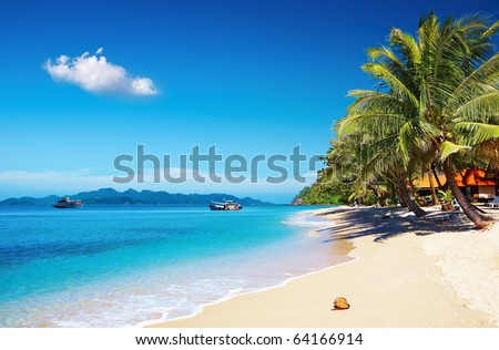 Tropical beach with coconut palms and bungalow, Thailand