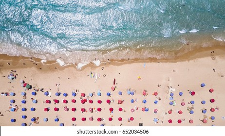 Tropical Beach With Colorful Umbrellas - Top Down Aerial View