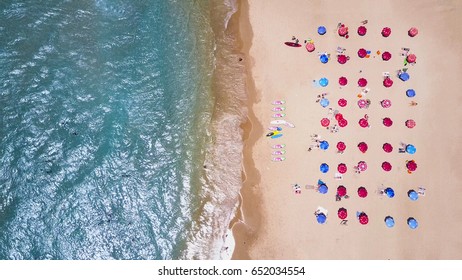 Tropical Beach With Colorful Umbrellas - Top Down Aerial View