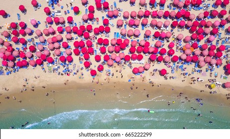 Tropical beach with colorful umbrellas - Top down aerial view