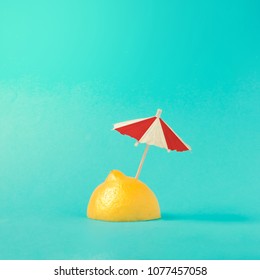 Tropical Beach Concept Made Of Lemon And Sun Umbrella. Creative Minimal Summer Idea.